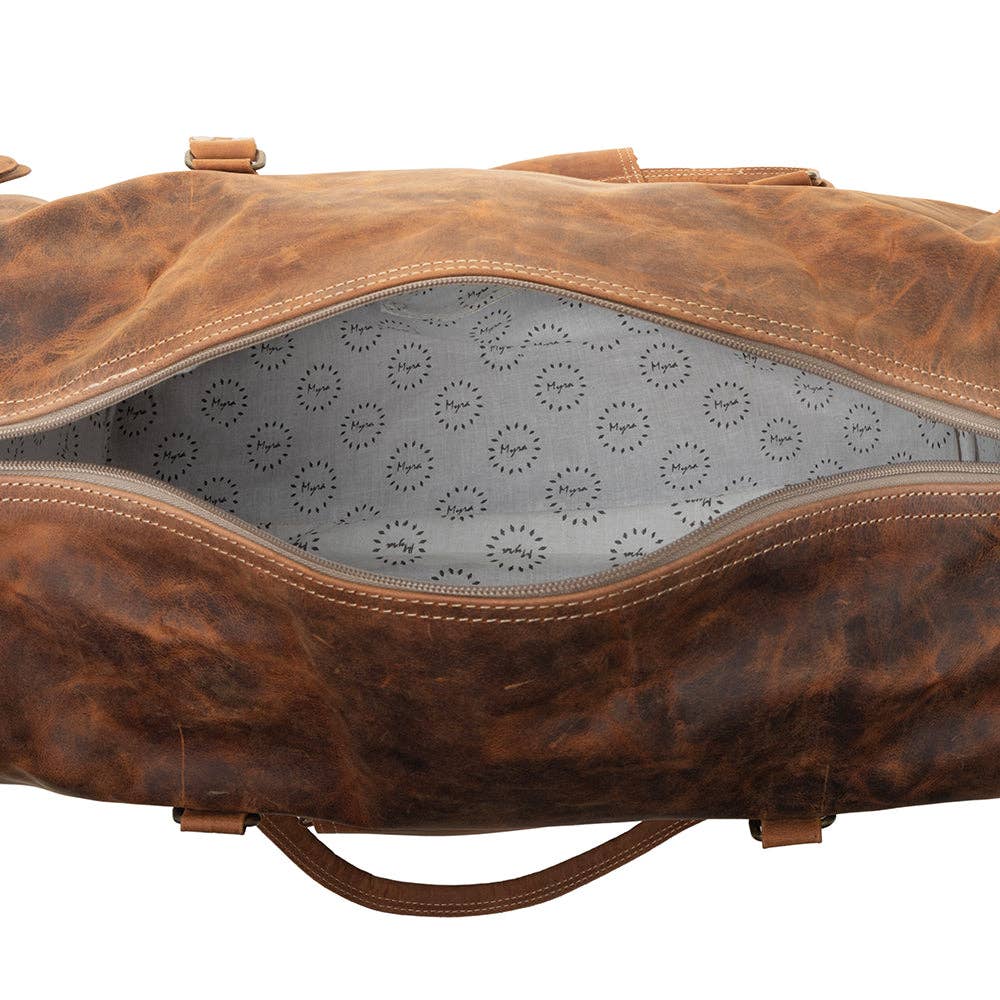 Amber brown leather traveller bag with a structured build and light-colored patterned lining, perfect for weekend getaways.