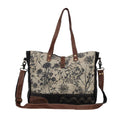 Floral-print messenger bag featuring a structured shape, multiple pockets, a shorter handle, and a longer shoulder strap.