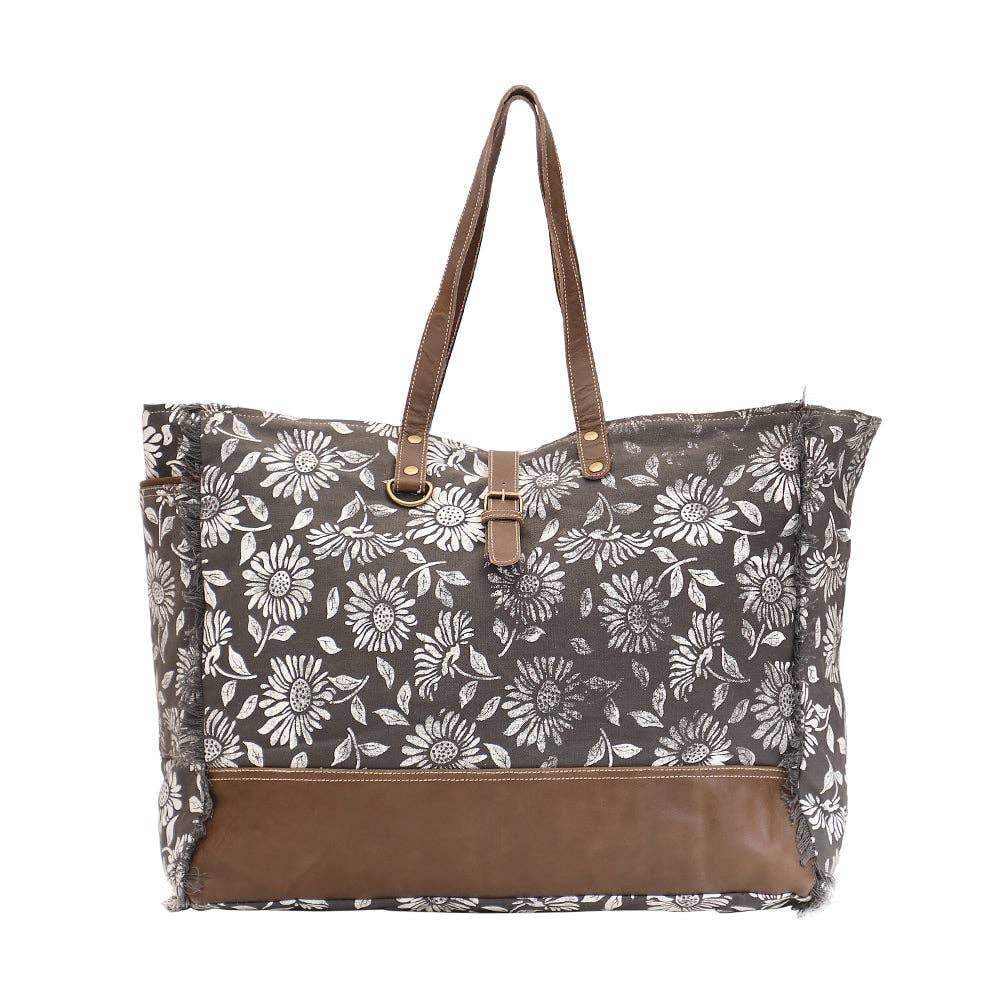 Floral weekender bag with leather trim, featuring a zipper closure and spacious compartments for all your travel essentials.