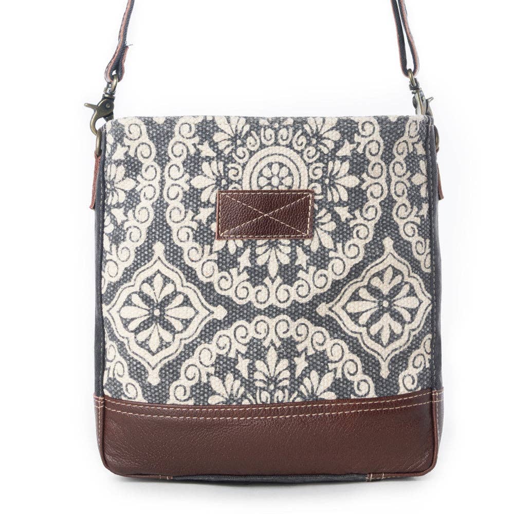 Stylish shoulder bag featuring a patterned design with a mix of light and dark colors, perfect for everyday use.