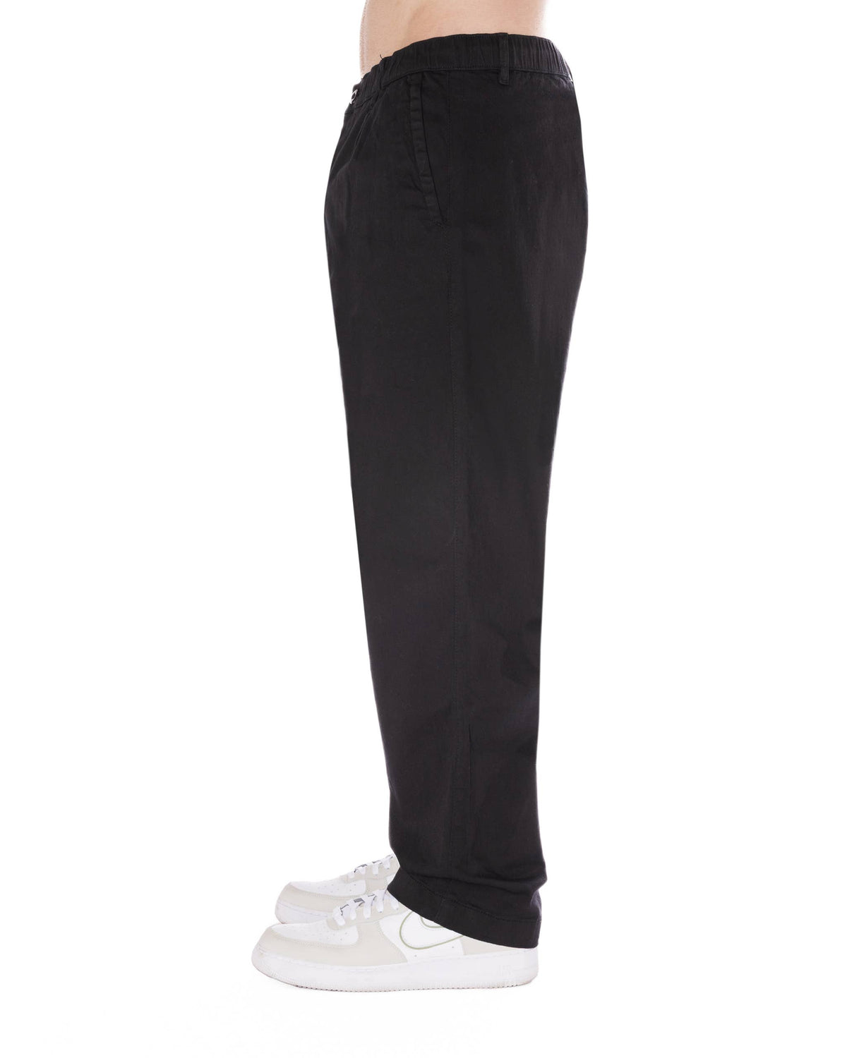 Relaxed fit black pants featuring an elastic waistband and drawstring for comfort and style.