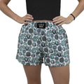 Boxer shorts featuring a fun circular pattern in green and black on a white background with an elastic waistband.