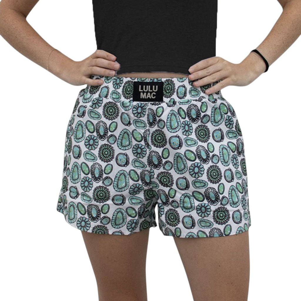 Boxer shorts featuring a fun circular pattern in green and black on a white background with an elastic waistband.
