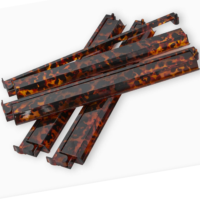 Set of four mahjong racks featuring a tortoise shell pattern in dark brown and amber tones, designed for stylish gameplay.