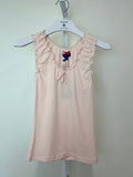 Pink sleeveless tank top with a ruffled neckline and delicate bow, featuring a fitted silhouette for a chic summer look.