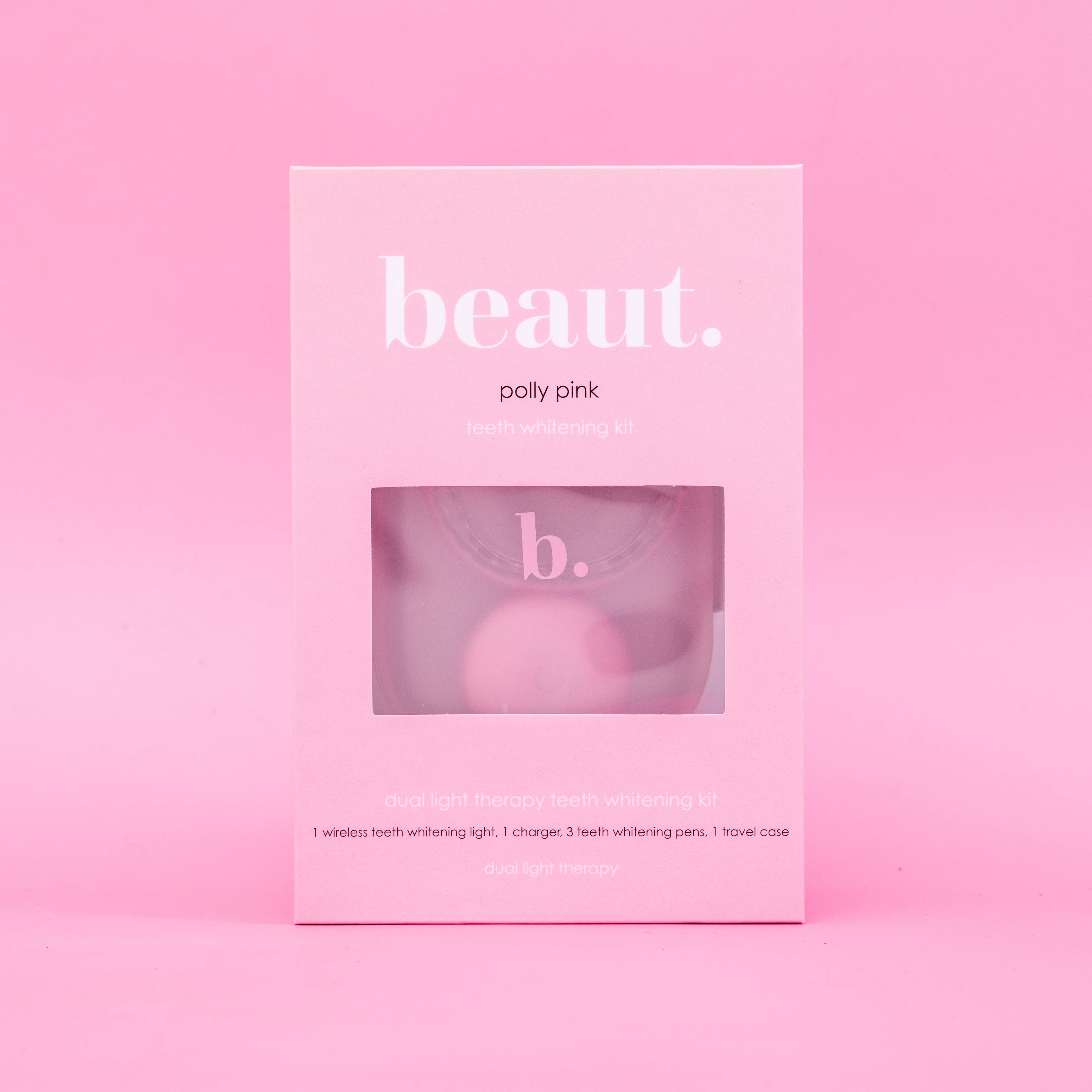Polly Pink Kit displayed in a pink box with a window, featuring a wireless teeth whitening device and blue light therapy details.
