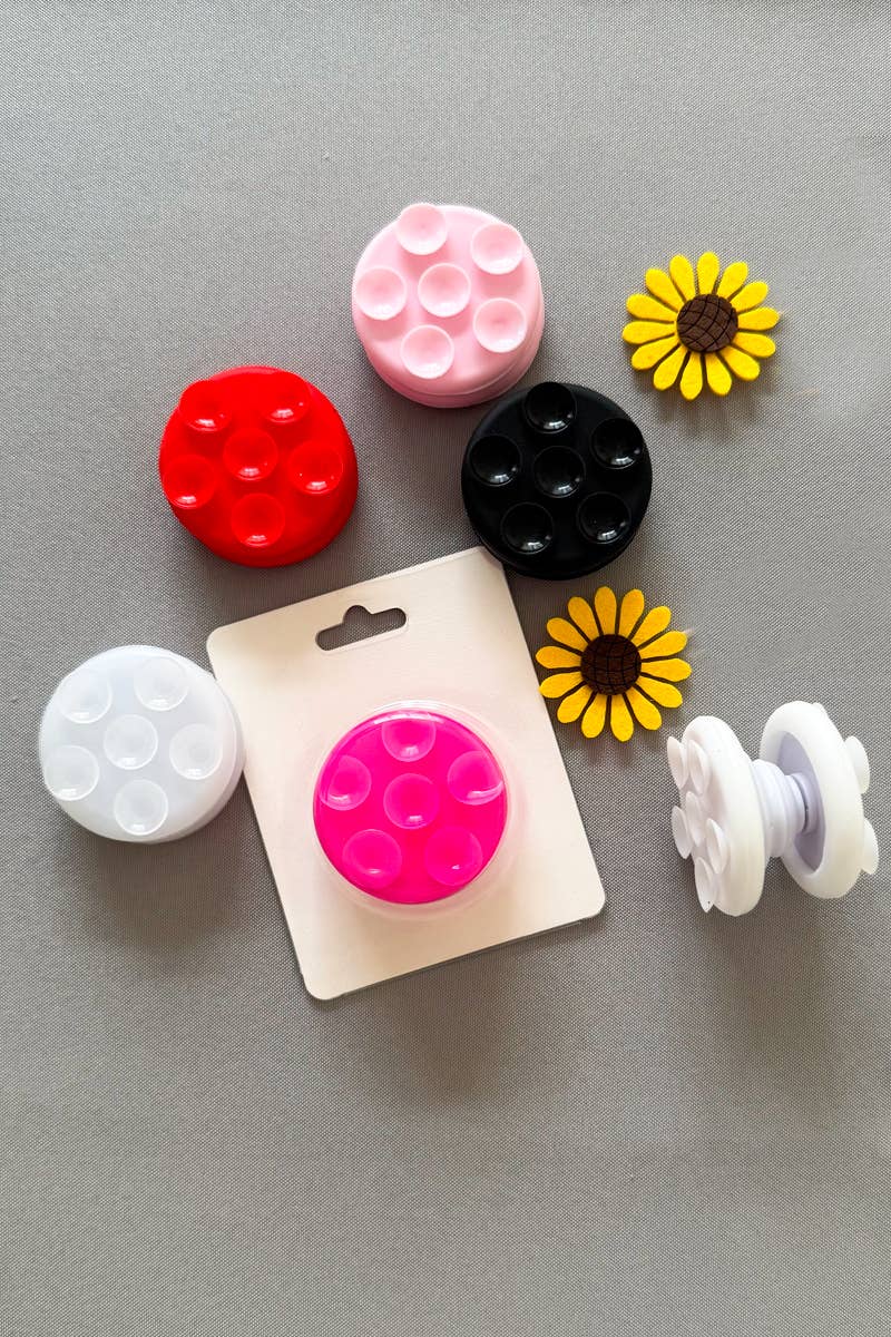 Multiple Tik Tok Pop Socket Suction Cup Phone Grips in various colors, showcasing their durable design and strong adhesive base.