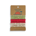 A set of hair tie bracelets in green, red, and beige, featuring a sun and palm tree design, perfect for everyday use.