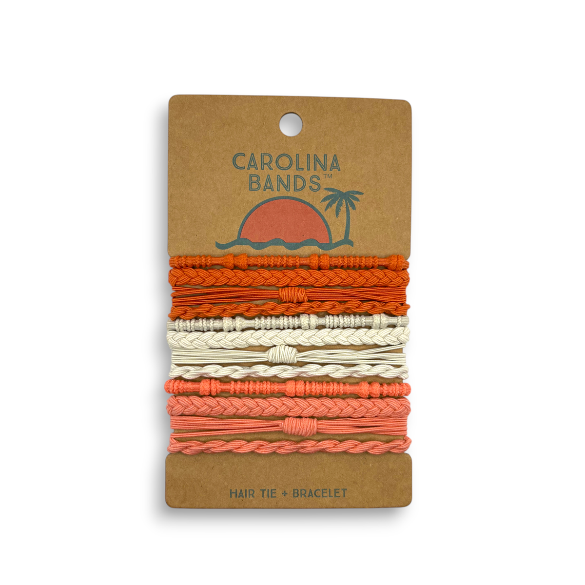 A set of braided and twisted hair tie bracelets in shades of orange, cream, and coral on a cardboard backing.