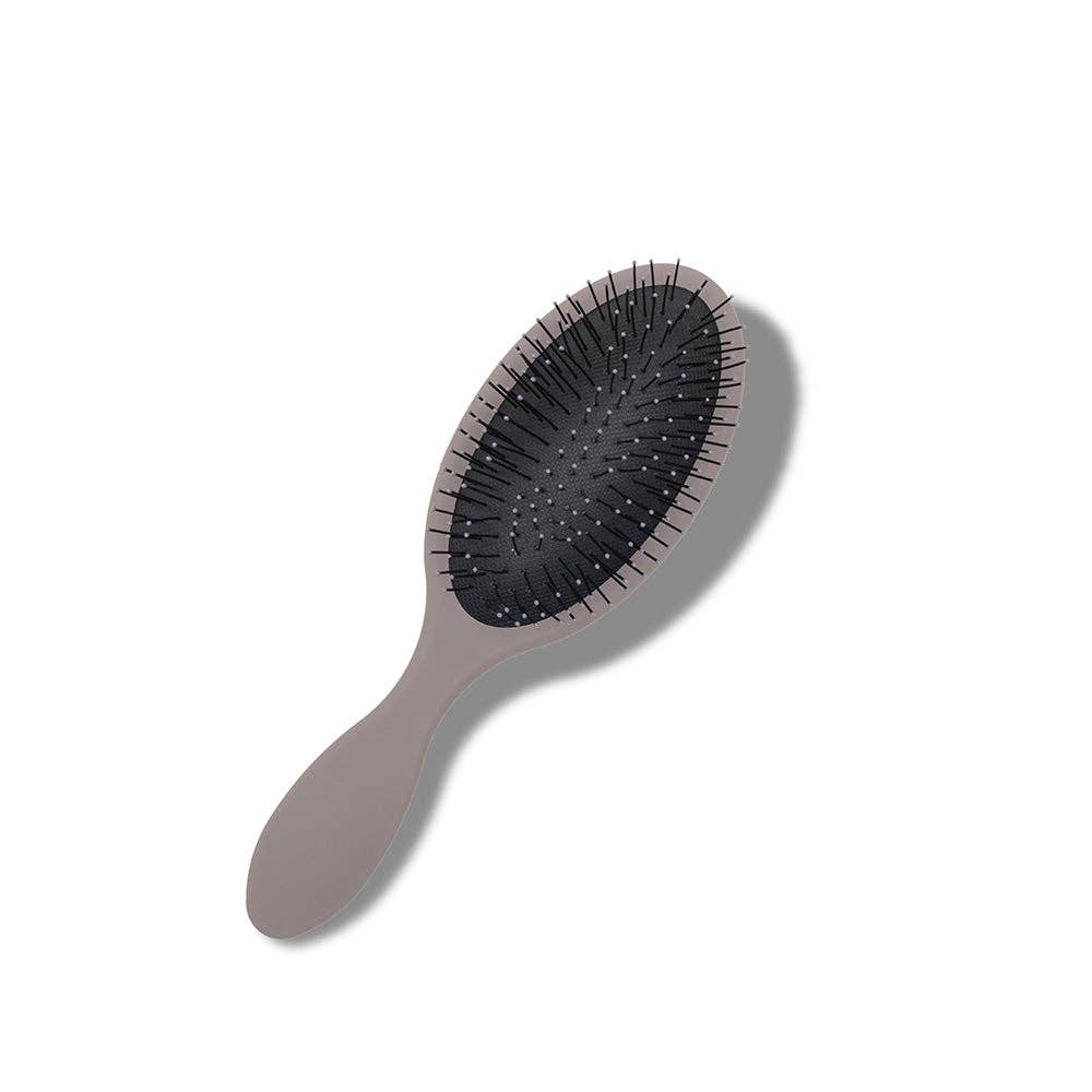 Sleek oval-shaped hairbrush with a cloud gray handle and full bristles, featuring unique designs on the back.