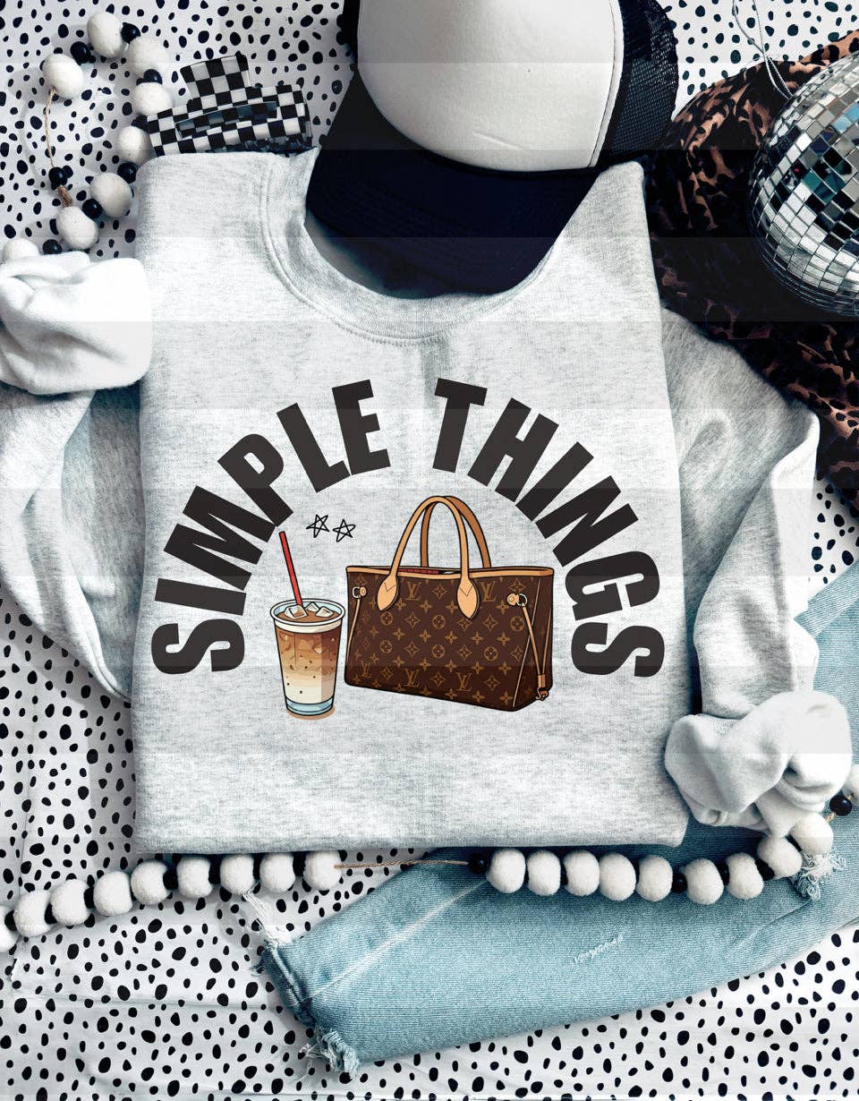Light gray sweatshirt featuring the text 'SIMPLE THINGS' with illustrations of a drink and a handbag. Unisex fit for casual wear.