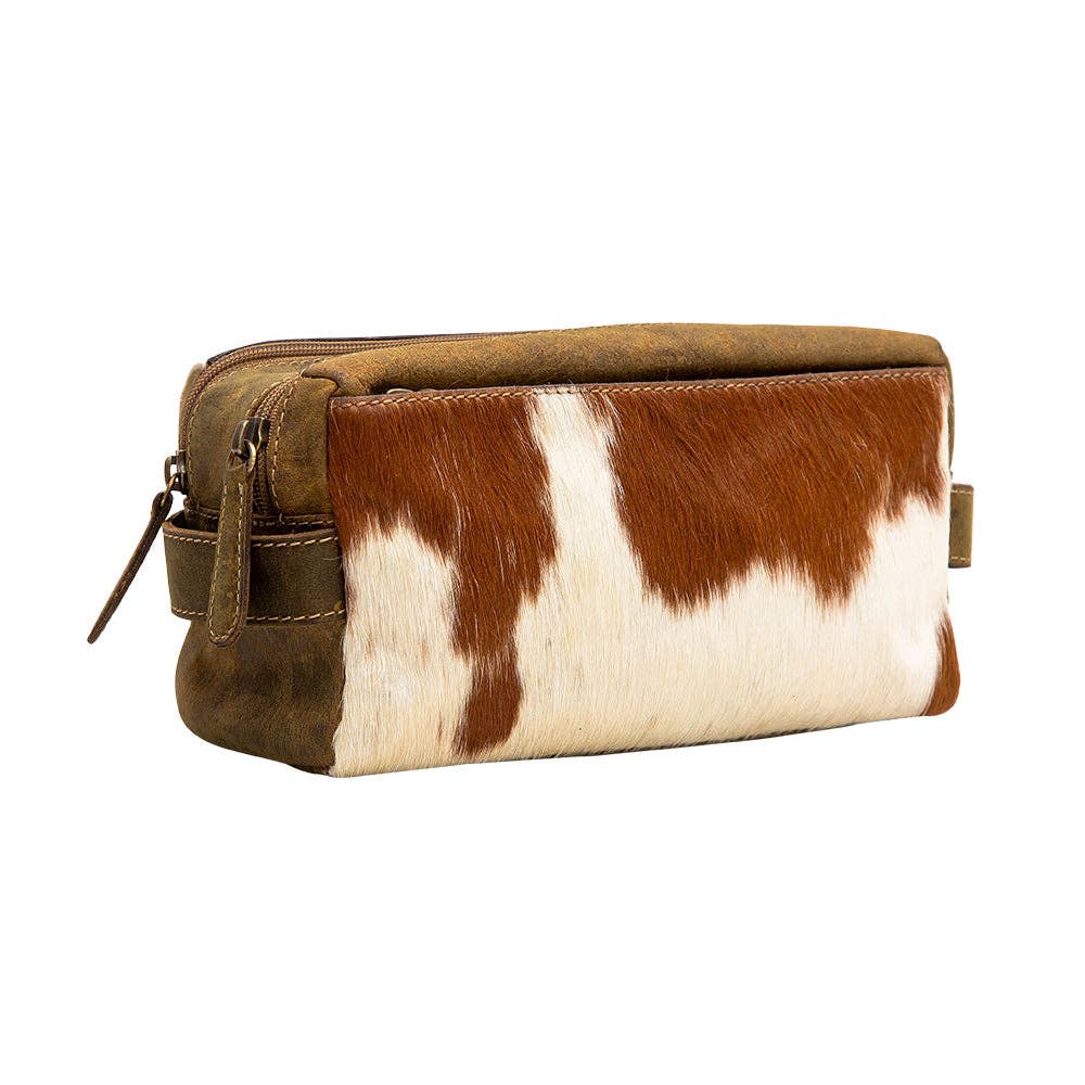 Rectangular pouch in hair-on hide and leather with a zipper closure and side handle, featuring brown and white patterns.