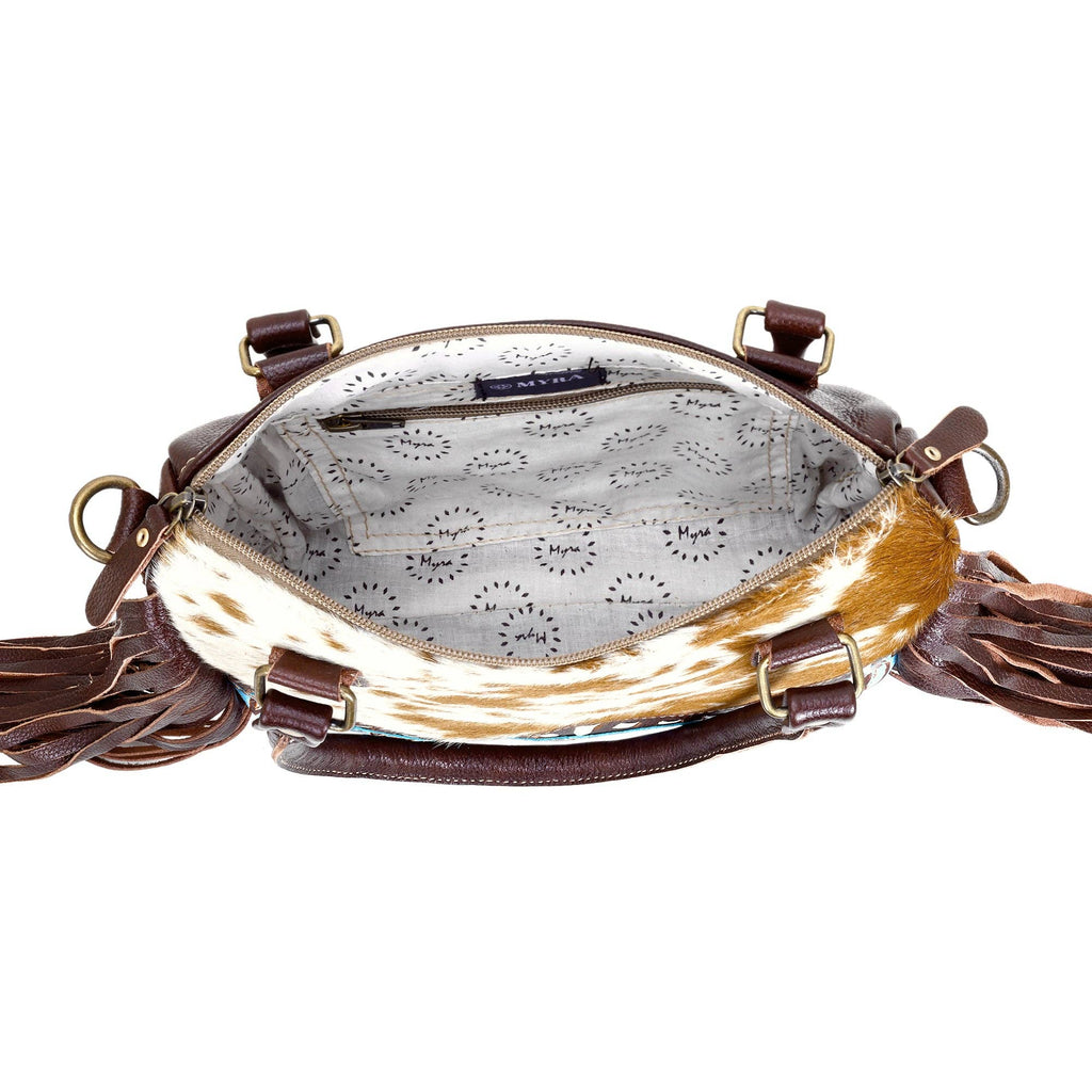 Chic brown hairon leather concealed carry bag with fringe detailing and adaptable leather straps.