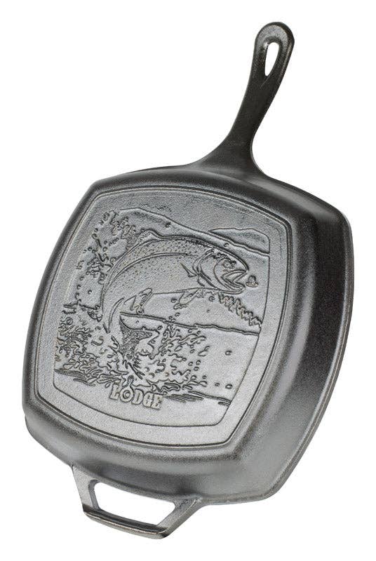 Detailed rainbow trout design on a black cast iron grill pan, perfect for outdoor cooking and grilling.
