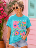 Vibrant floral design in pink, blue, and yellow on a relaxed fit Sunshine State of Mind Tee. Perfect for a casual, vacation vibe.