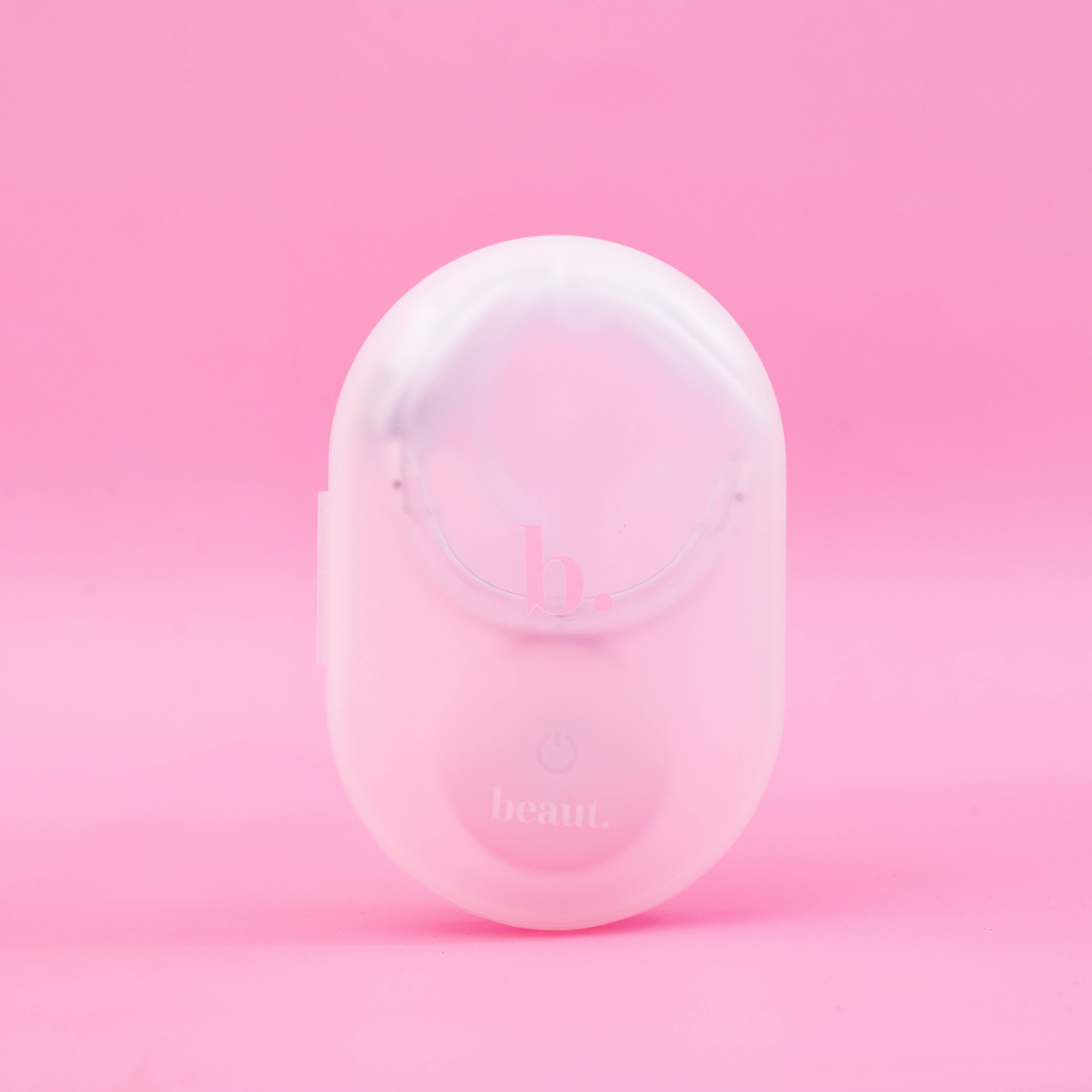Compact pink waterproof device featuring a power button, designed for wireless blue and dual light therapy treatments.