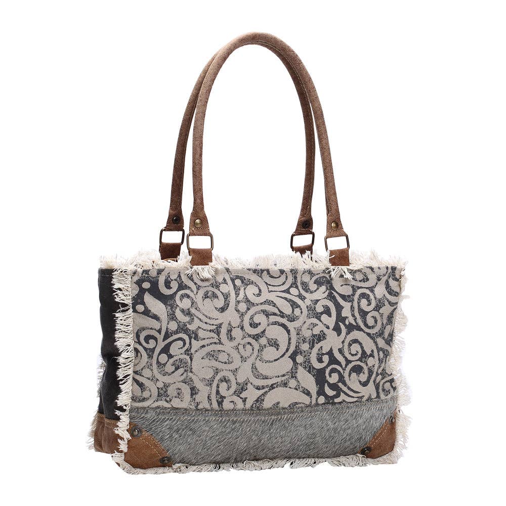 Leaf print small bag featuring canvas and leather elements, spacious main compartment, and zippered pocket for organization.