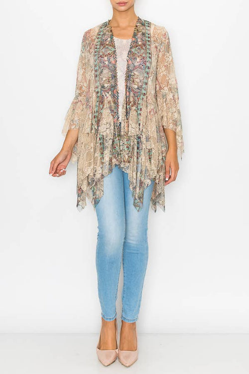 Lace tiered cardigan with an open front and flowing sleeves, styled with light blue jeans and nude heels.