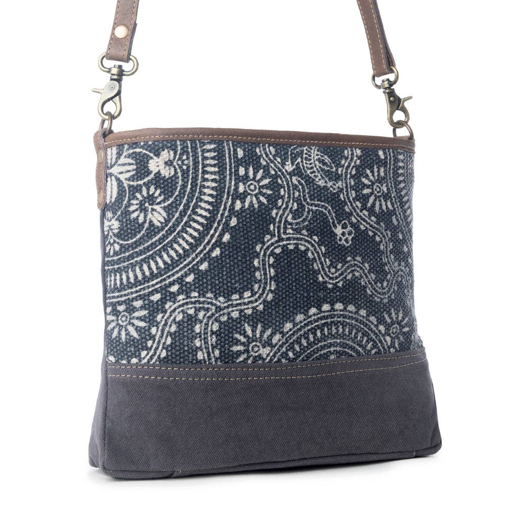 Navy kilim shoulder bag featuring intricate light patterns on a dark background, with a structured shape and shoulder strap.