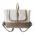 Grey and patterned backpack featuring a leather flap, adjustable straps, and a top handle for easy carrying.