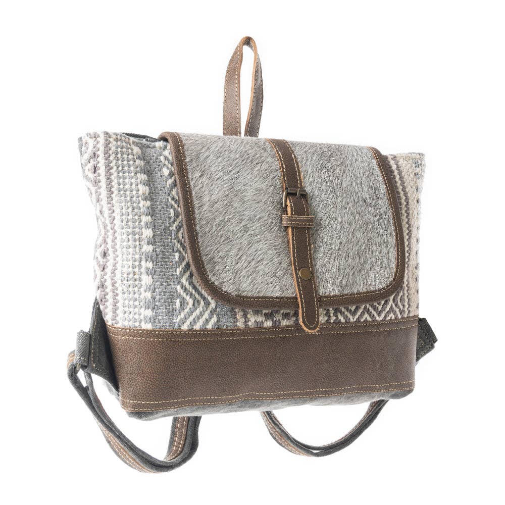 Grey backpack with a leather flap and adjustable straps, featuring a patterned texture on the front. Perfect for everyday use.