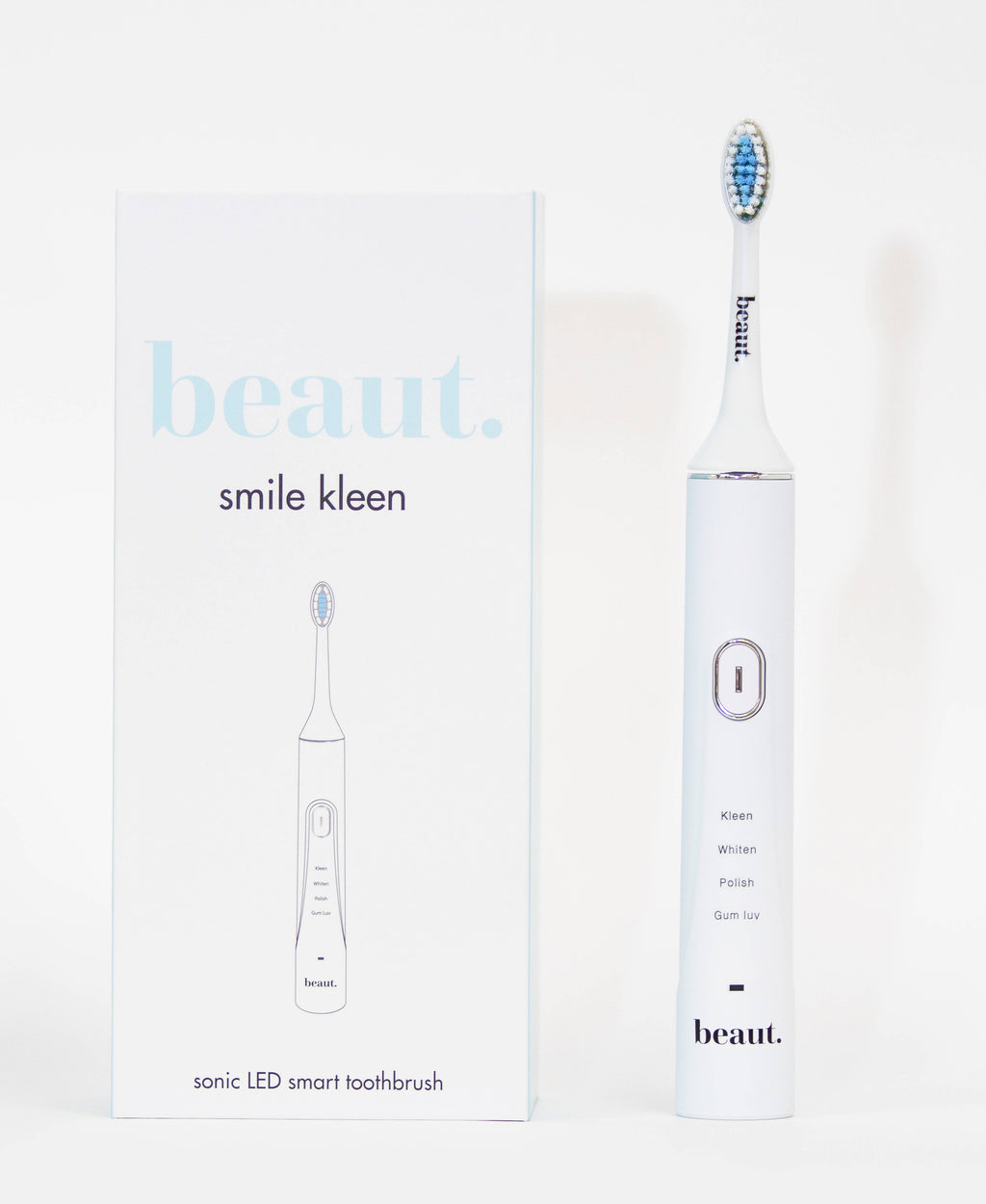 Sleek white sonic toothbrush with blue bristle head and minimalistic packaging showcasing Smile Kleen branding.