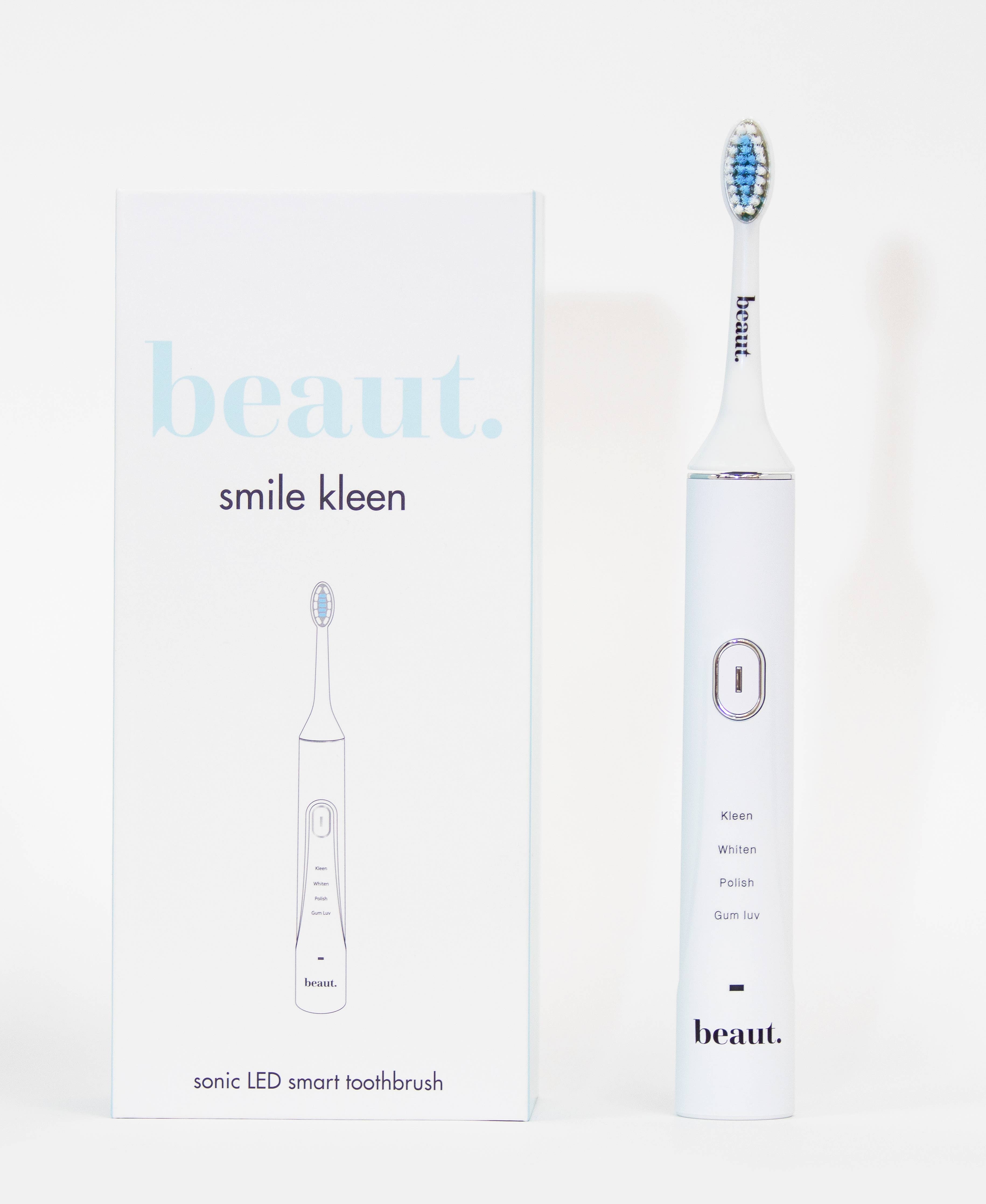 Sleek white sonic toothbrush with blue bristle head and minimalistic packaging showcasing Smile Kleen branding.
