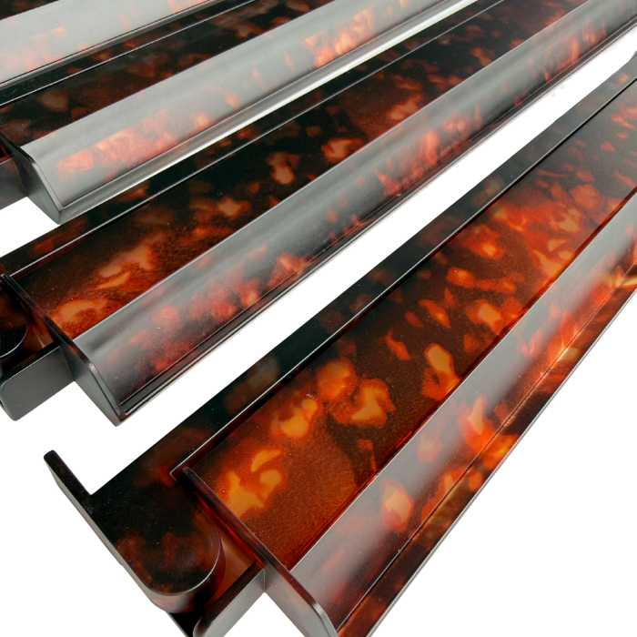 Four tortoise shell Mahjong racks arranged side by side, showcasing a glossy finish with a mix of dark and light brown colors.
