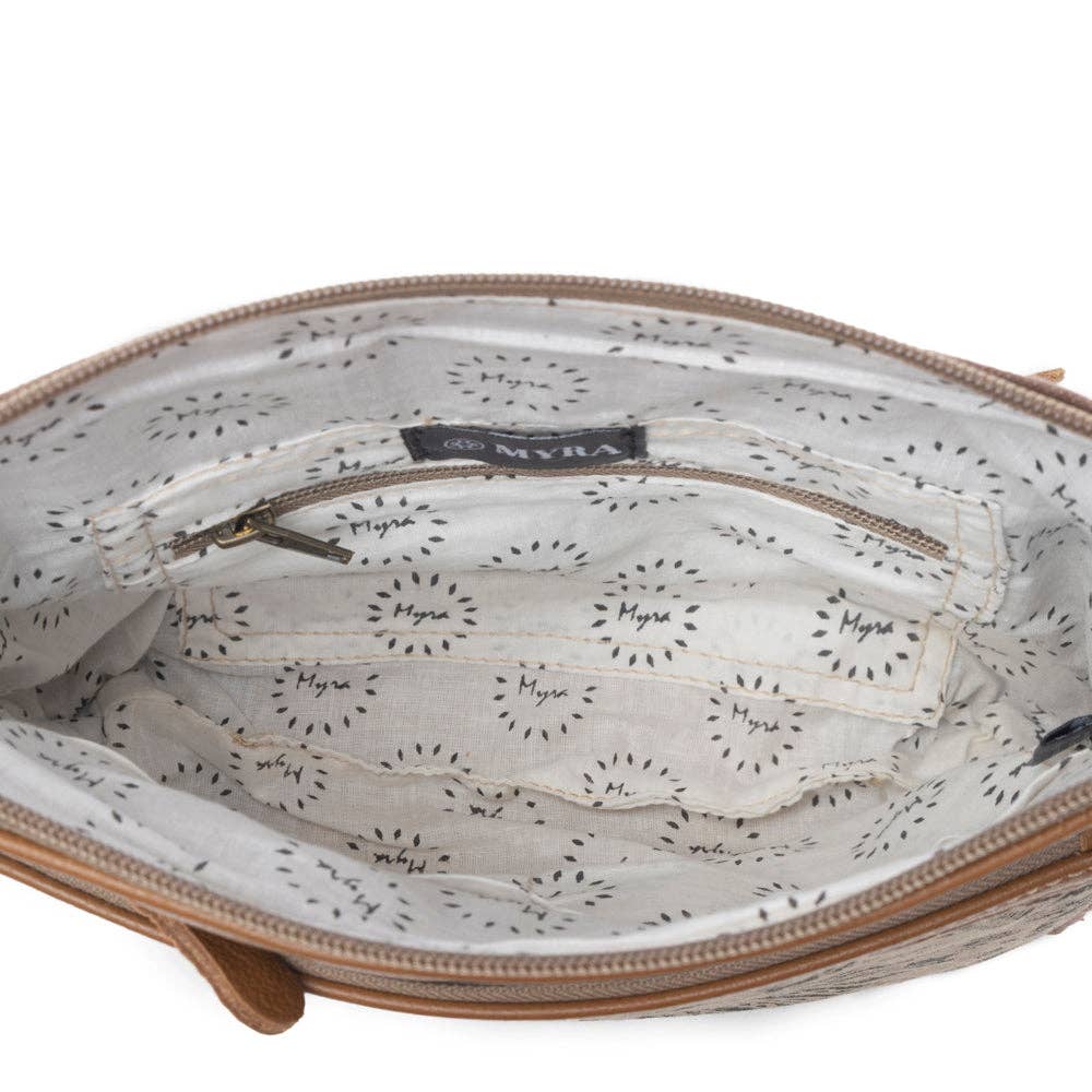 Light-colored interior lining with a zippered pocket in the Dizzy Circle Small Crossbody Bag. Perfect for essentials on the go.