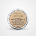 Round metal tin of Farmer's Hand Salve with a beige label, designed for soothing dry and cracked skin.
