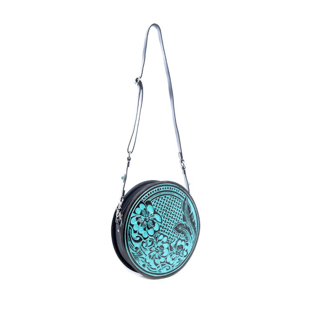 Round handbag featuring a turquoise floral design on the front, black reverse, and a detachable adjustable shoulder strap.