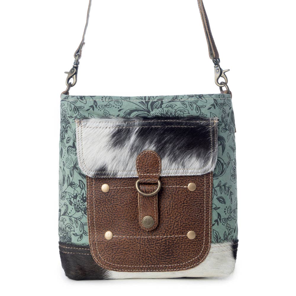 Stylish Eau De Nil Shoulder Bag featuring a patterned canvas body, hairon flap, and front pocket with button closure.