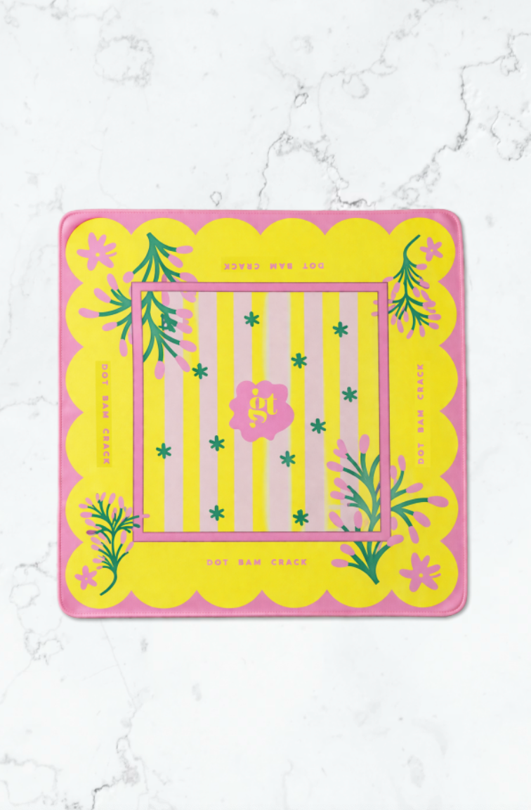 Square yellow mahjong mat with pink scalloped edges, featuring a striped pattern and floral designs, perfect for game nights.