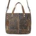 Dark brown handbag with fringed details, two front pockets, and both shoulder strap and top handles for versatile styling.