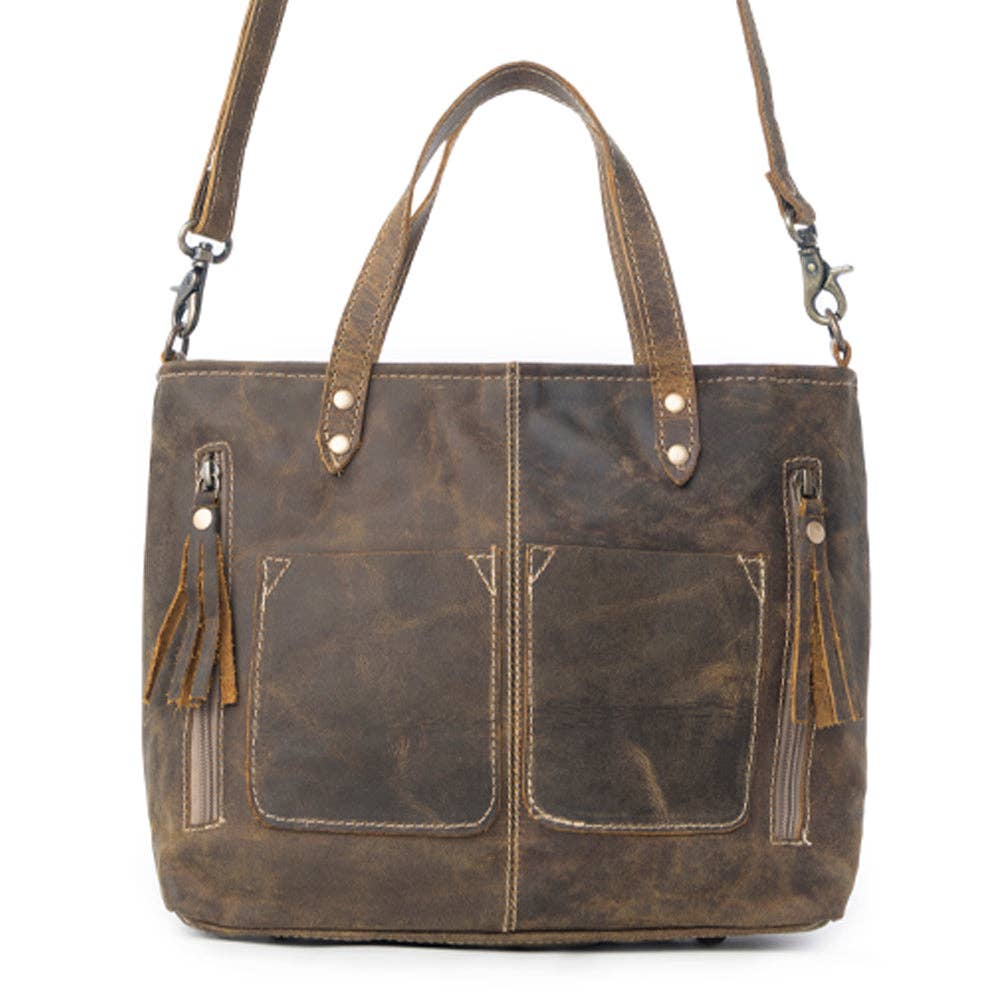 Dark brown handbag with fringed details, two front pockets, and both shoulder strap and top handles for versatile styling.