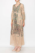 Long, flowing turquoise lace dress with bell sleeves and a floral pattern, featuring a V-neckline. Perfect for vacations.