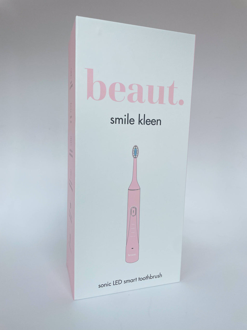 Pink Smile Kleen Sonic LED smart toothbrush packaging featuring a clean design and minimal graphics.