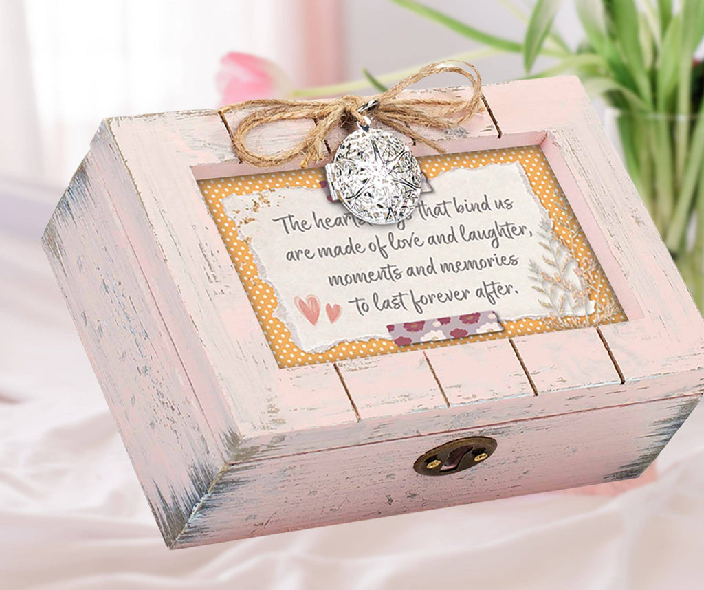 Petite wooden music box with a rustic pink finish, featuring a heart locket and an art print about love and memories.