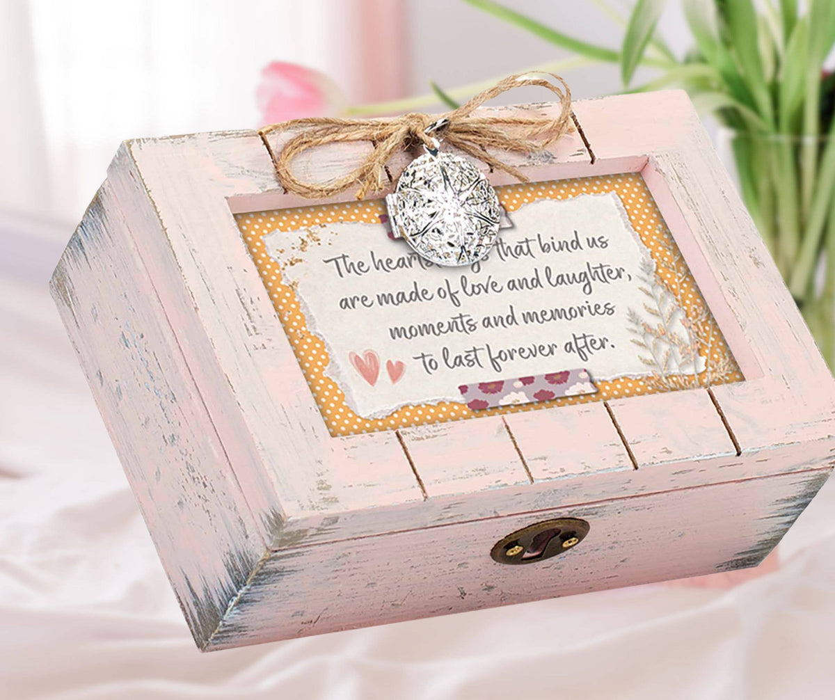 Petite wooden music box with a rustic pink finish, featuring a heart locket and an art print about love and memories.