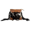 Hand-tooled leather bag featuring a scalloped design, black and white hair-on hide, and stylish black leather fringe.