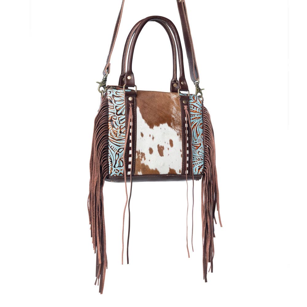 Fringe leather bag with a broad handle, spacious design, and unique hairon detailing for everyday use.