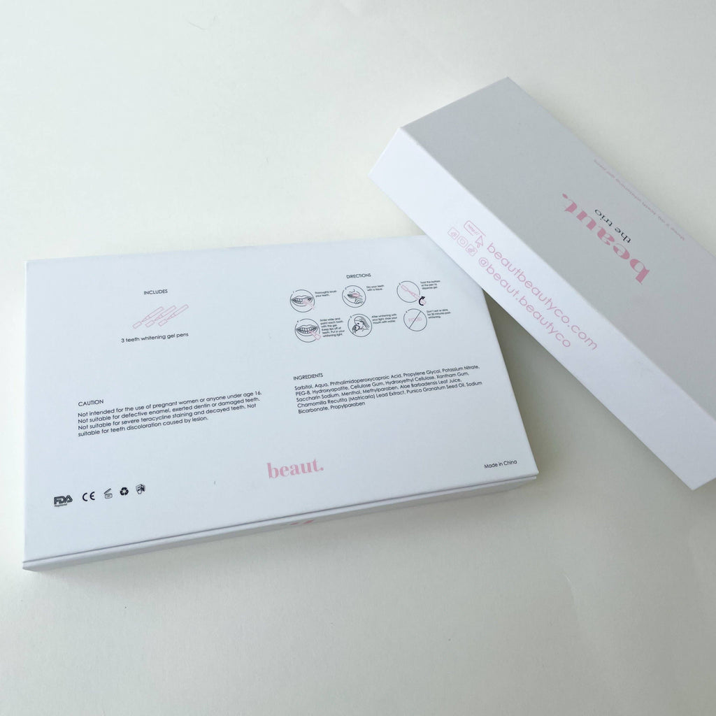 White box labeled 'The Trio' with '3 Smile Pens Pack' and instructions for teeth whitening on the back.