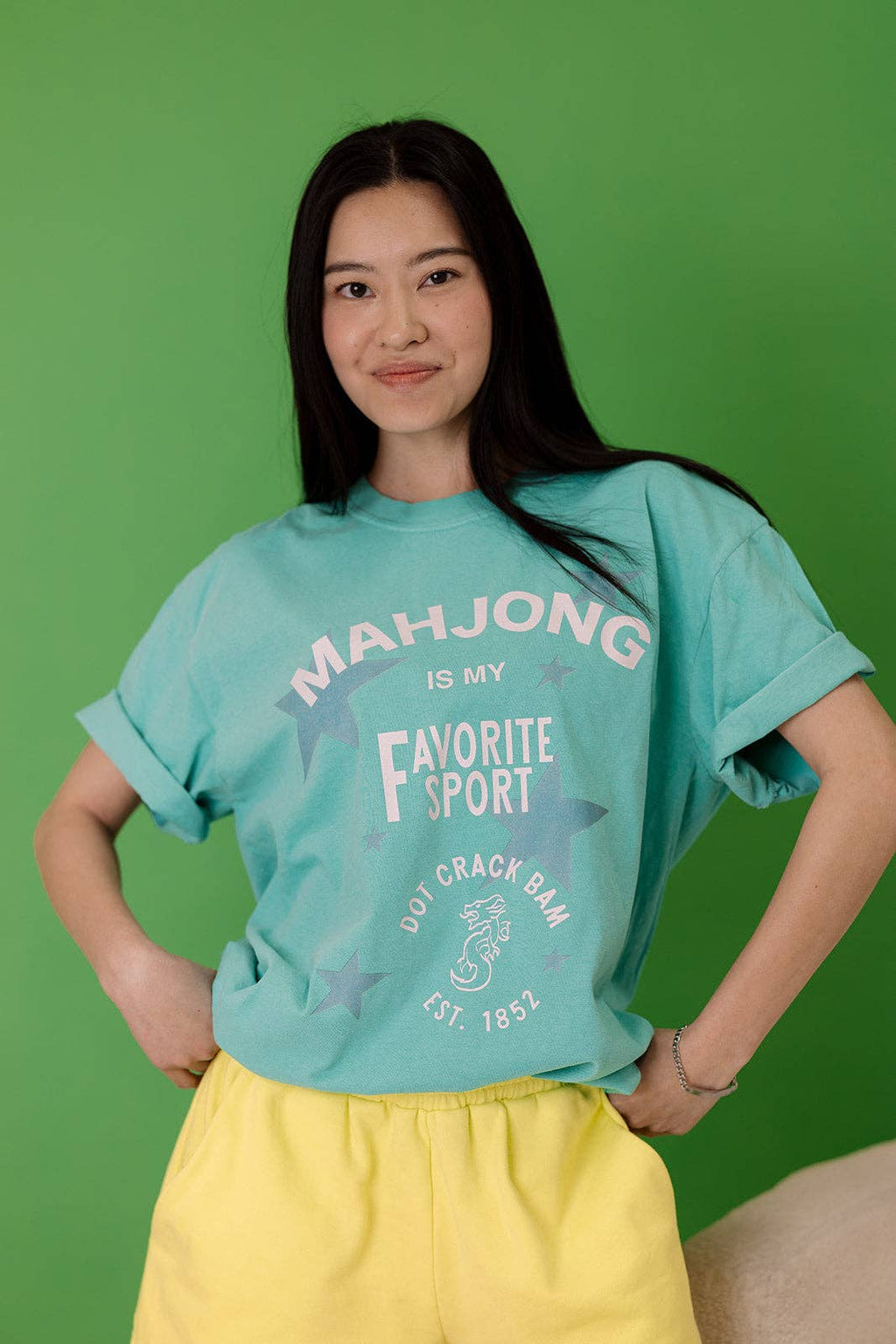 Turquoise tee featuring playful 'MAHJONG IS MY Favorite SPORT' graphic in a relaxed fit, perfect for casual wear.