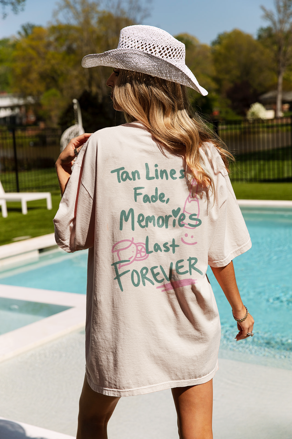 Light ivory Bikini Tee featuring colorful text that reads 'Tan Lines Fade, Memories Last FOREVER.' Perfect for summer wear.