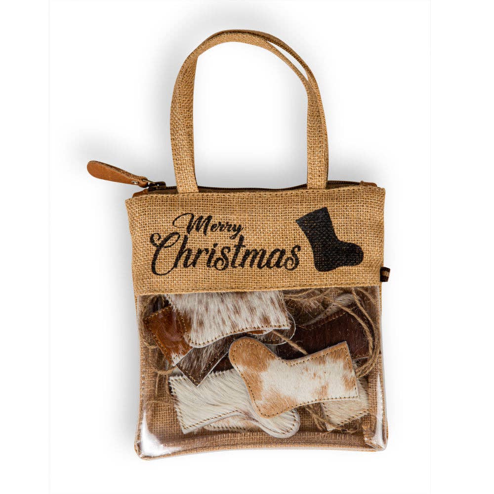 A woven burlap bag with a handle holds ten unique brown hair-on hide stockings, each with stitched edges.
