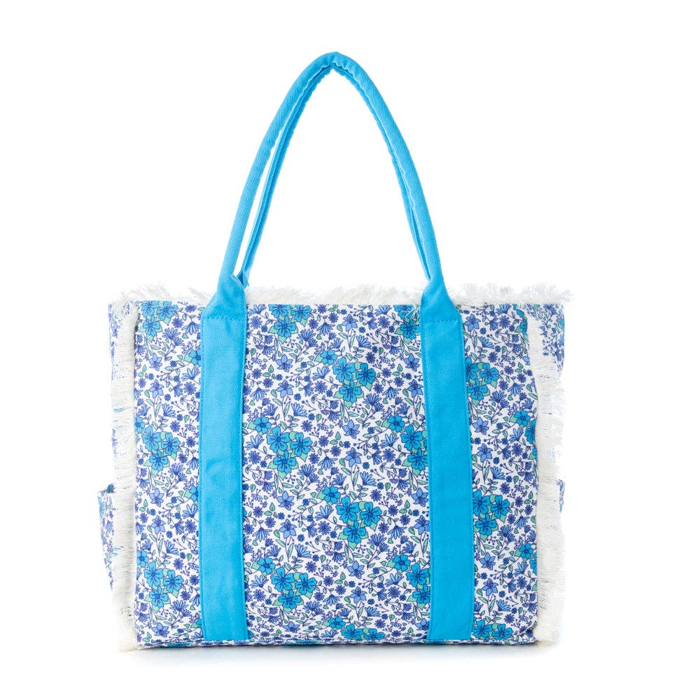 Wildflower print weekender bag with fringe detailing and blue carry straps, includes a beach mat for your summer adventures.