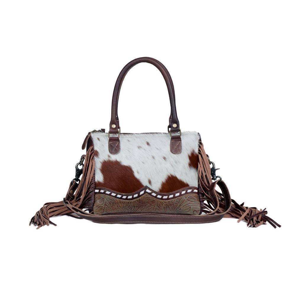 Chic brown hairon leather concealed carry bag with fringe detailing and adaptable straps. Perfect blend of style and function.