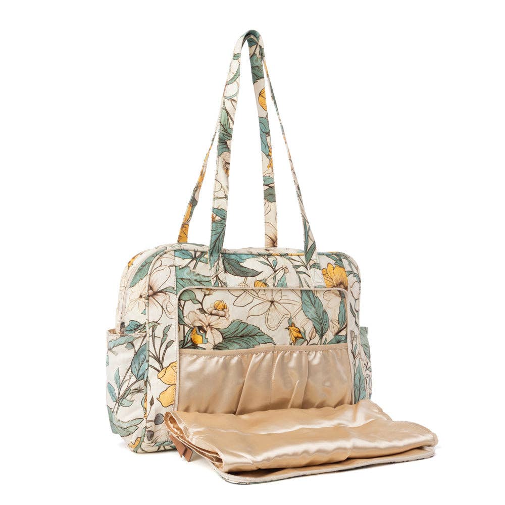Floral ochre and green diaper bag with two handles, spacious main compartment, and inside pocket for organization.