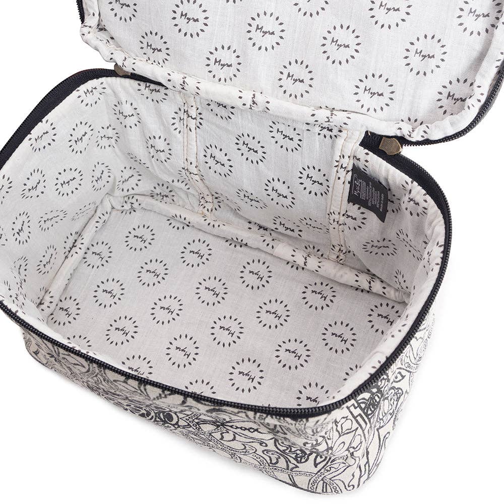Black and white woven canvas toiletries bag with a wrap-around zipper and ebony leather handle.