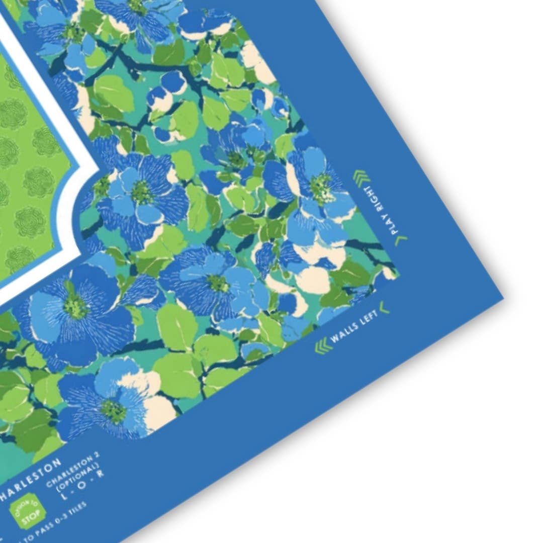 Vibrant floral Mahjong mat with blue and green shades, featuring a blue border and directional indicators for gameplay.